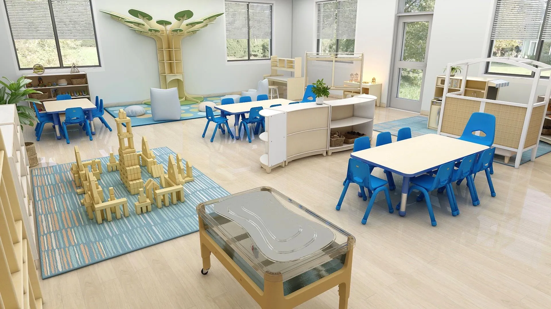 Design rendering of the IGA Pre-K classroom with a tree-shaped reading corner, group tables, and building-block stations